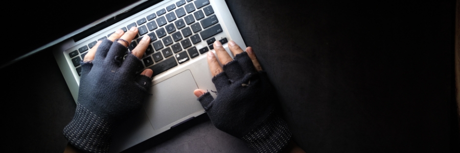 person wearing black gloves on a keyboard